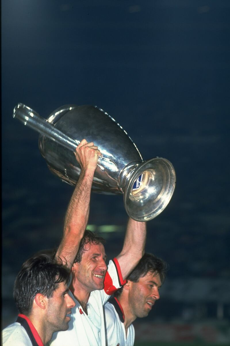 Franco Baresi holds the European Cup aloft after Milan's victory in the final against Benfica in Vienna, May 1990