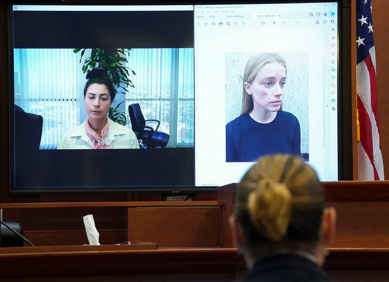 Depp listens as Pennington testifies in a recorded video deposition, as a picture of Heard appears on screen. AFP