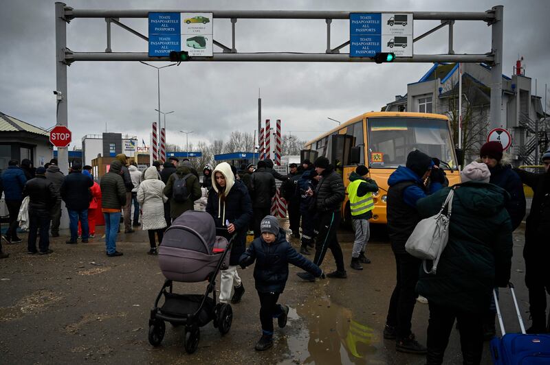 Refugees walk after crossing the Moldova-Ukraine border near the town of Palanca. AFP