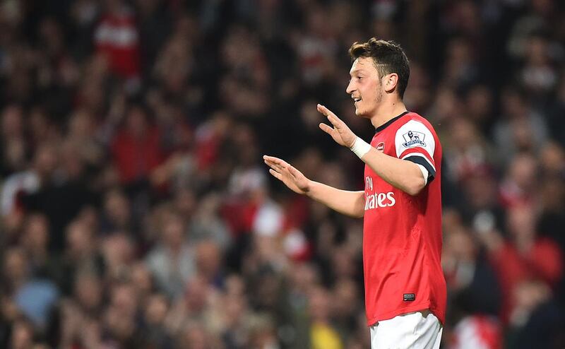 Arsenal's German midfielder Mesut Ozil celebrates after scoring his team's second goal during the Premier League match against Newcastle United at the Emirates Stadium in London on April 28, 2014. Ben Stansall / AFP