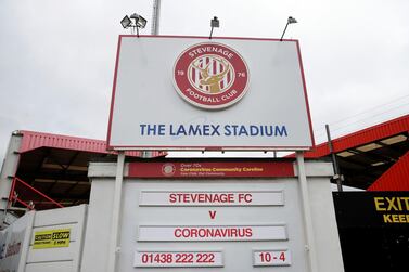 Stevenage, who play in the fourth tier of English football, display a fixture sign at the entrance to their Lamex Stadium showing Stevengage v Coronavirus. Stevenage are among many lower league clubs in England who face an uncertain future due to the pandemic. AP Photo