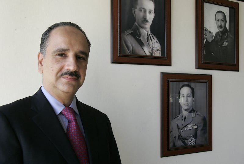 Sherif Ali bin Hussein, great-nephew of Iraq's King Faisal I, poses for a photograph at his house in Baghdad in 2007.  Pictures on the background: Iraq's King Ghazi (L), Iraq's King Faisal II (C) and Prince Abdul Illah (R), uncle of King Faisal II. AFP