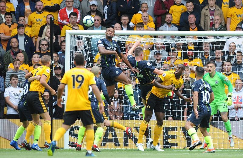 Manchester City's Vincent Kompany, center left, jumps for the ball. AP Photo