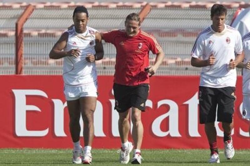Dubai, December 28, 2010 - AC Milan's Ronaldinho (in white) runs with fitness trainer (NO PICTURE ON WEBSITE) during the team's practice for their  upcoming Emirates Challenge Cup match against Al Ahli in Al Rashid Stadium in Dubai, December 28, 2010. (Jeff Topping/The National)