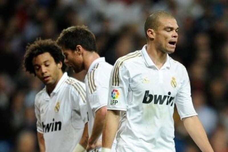 Real Madrid's Portuguese defender Pepe (R) gestures during the Spanish league football match Real Madrid vs Valencia at Santiago Bernabeu stadium on April 8, 2012 in Madrid. The match ended in a 0-0 draw.  AFP PHOTO/ DANI POZO
 *** Local Caption ***  267098-01-08.jpg