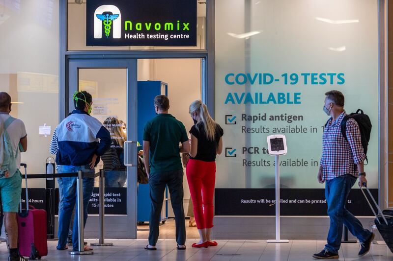 Passengers queue outside a Covid-19 testing centre at Cape Town International Airport, South Africa. Bloomberg