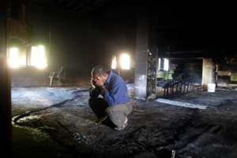 A Palestinian reacts in a mosque after it was gutted by a fire in the West Bank village of Libban al-Sharqia near Nablus May 4, 2010. Palestinians accused Jewish settlers of setting fire to the mosque in the occupied West Bank on Tuesday, an incident that coincided with a U.S. envoy's mission to get Middle East peace talks going. Israeli security officers were at the scene investigating the fire but have not determined its cause.

  REUTERS/Abed Omar Qusini (WEST BANK - Tags: POLITICS DISASTER RELIGION) *** Local Caption ***  JER08_PALESTINIANS-_0504_11.JPG *** Local Caption ***  JER08_PALESTINIANS-_0504_11.JPG
