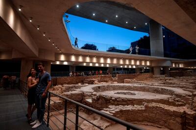 People visit a new section housing the remains of an ancient Athens neighbourhood beneath the Acropolis museum in Athens, on its opening day on June 21, 2019, marking the museum's 10-year-anniversary. The new 4,000-square-metre (43,000-square-feet) extension displays the remains of ancient baths and hot water pipes, public latrines, homes, wells and workshops, organisers said. Most of the remains are Roman and Byzantine but "some date back to Classical Athens," the museum director said. / AFP / LOUISA GOULIAMAKI
