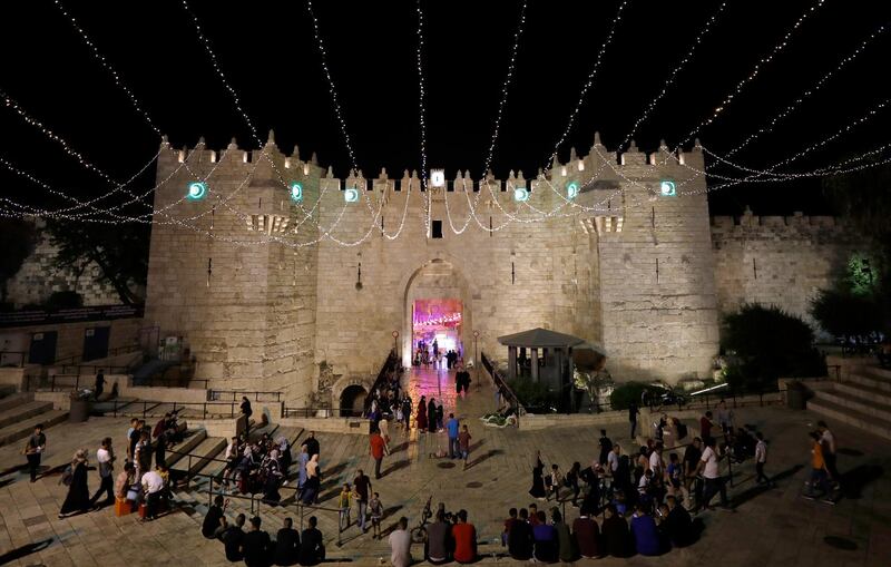 A view of Damascus Gate of Jerusalem's old city, decorated with lights, as Palestinian Muslims walk during the holy fasting month of Ramadan.  EPA