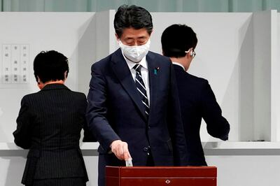 Japan's outgoing Prime Minister Shinzo Abe casts his ballot during the Liberal Democratic Party's (LDP) leadership election in Tokyo on September 14, 2020. Japan's ruling party votes on September 14 for its next leader, with top government adviser Yoshihide Suga all but certain to win and replace Shinzo Abe as the country's new prime minister. / AFP / POOL / Eugene Hoshiko
