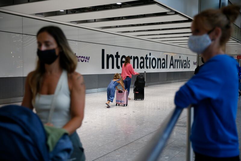 A traveller exits through the International Arrivals gate at Heathrow Airport.  Getty Images