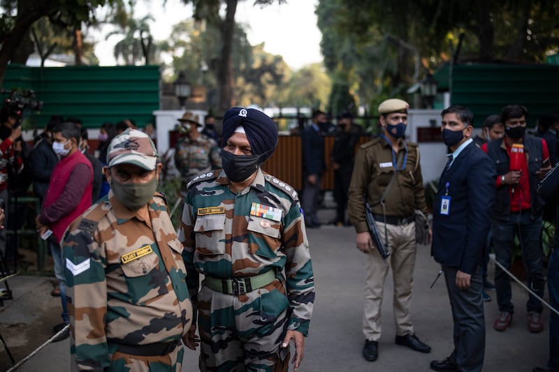 Army personnel and members of the media outside the residence of Gen Bipin Rawat in New Delhi after news of the helicopter accident broke. AP Photo
