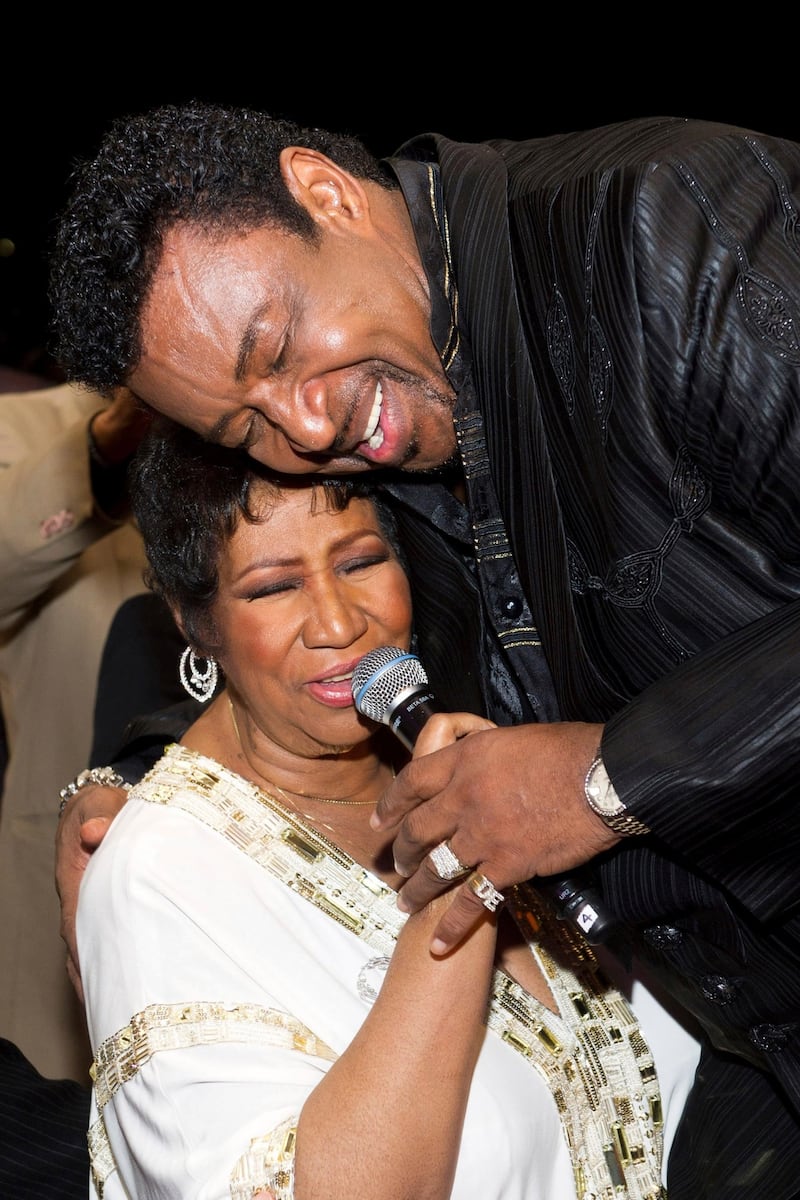 FILE- In a March 25, 2011 file photo, Aretha Franklin sings with Dennis Edwards of The Temptations at her 69th birthday party, in New York.  Edwards, former member of the famed Motown group The Temptations, has died. He was 74. His longtime booking agent says Edwards died Thursday, Feb. 1, 2018 in Chicago after a long illness.    (AP Photo/Charles Sykes_File)