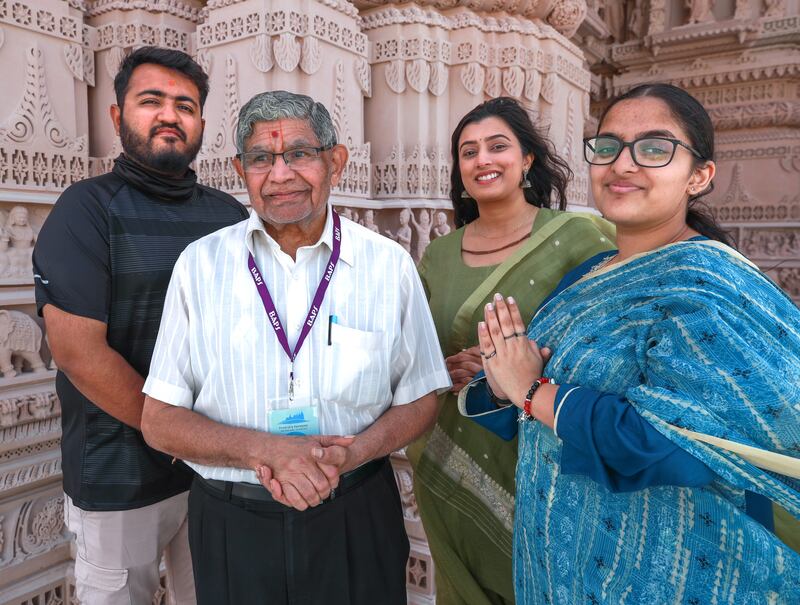 From left, devotees from the UAE and overseas, Suraj Parmar, Shashikant Depala, Priyanka Lodhia and Niyanta Patel are among dozens who gather at the site to help ready it for a February opening.  Victor Besa / The National