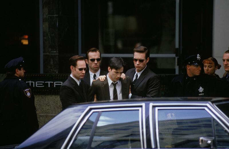 Keanu Reeves, Hugo Weaving, Robert Taylor & Paul Goddard in The Matrix. Courtesy Warner Bros.