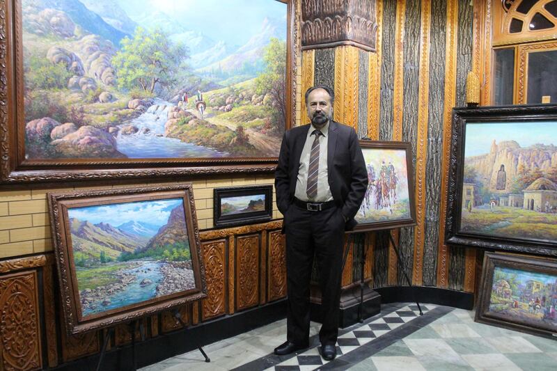 Dr. Mohammad Yousef Asefi by his paintings on the second floor of his gallery. His work often showcases Afghanistan’s landscapes and Afghan’s way of life , past and present. The picture was taken prior to the power cut that was suspected to have been caused by the Taliban. Photo by Sarvy Geranpayeh