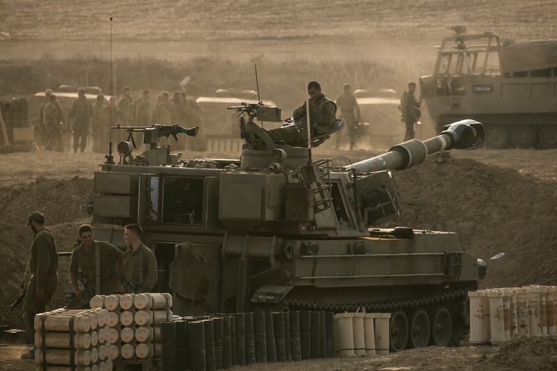 Israeli soldiers sit on top of a tank near the border with Gaza. Getty Images