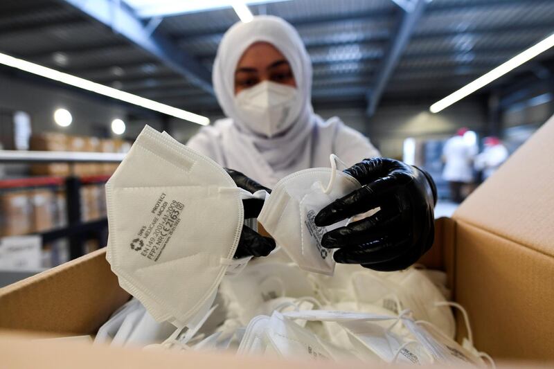 An employee packs FFP2 masks at a SWS Medicare factory in Altheim near Landshut, Germany. Reuters