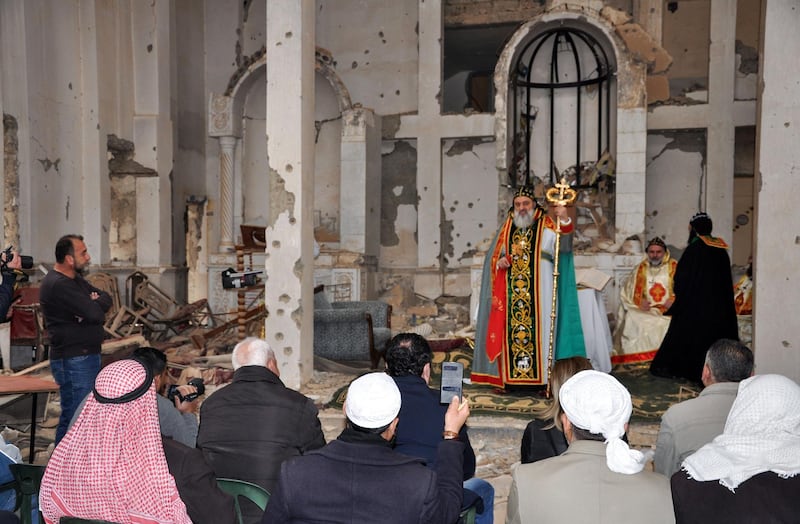 Syriac Orthodox Patriarch of Antioch, Ignatius Aphrem II, gives a sermon during mass at the heavily damaged Syriac Orthodox church of St. Mary in Syria's eastern city of Deir Ezzor on February 3, 2018. / AFP PHOTO / Ayham al-Mohammad
