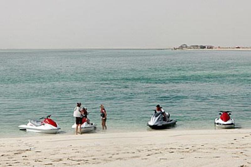 The map outlines zones across Abu Dhabi Island and beyond where powered vessels, such as boats, and powered water craft, such as jet skis, are prohibited.