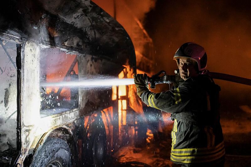 Rescuers put out a fire during a Russian air strike on Kyiv. EPA