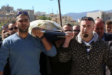 Relatives carry the body of 14-year-old student Hind Azzeh, a victim of a flash flood that swept away a group of middle school students and teachers visiting hot springs near the Dead Sea in 2018. AP