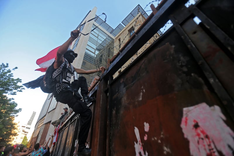 Lebanese protesters attempt to break into parliament as members of the security forces clash with demonstrators in Downtown Beirut.