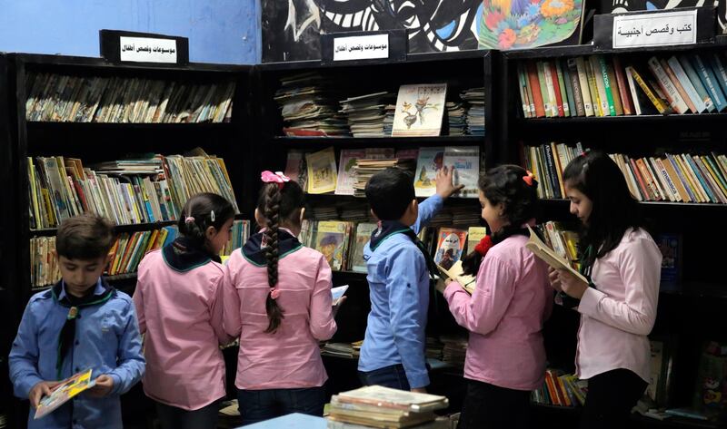 Students browse books at the Educational Academic Library in Damascus, Syria. EPA