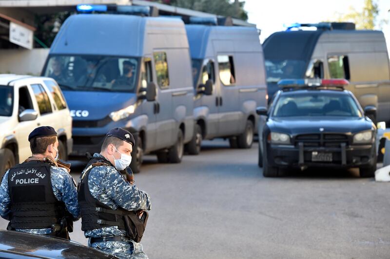 Lebanese policemen stand guard outside a detention center after dozens of prisoners escaped in Baabda.  EPA