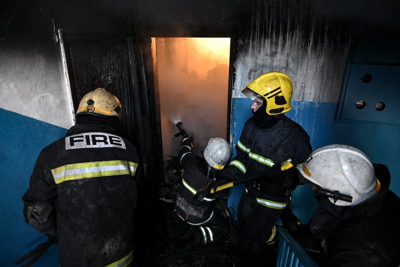 Firefighters tend to a fire after bombings in Chuguiv on February 24. AFP