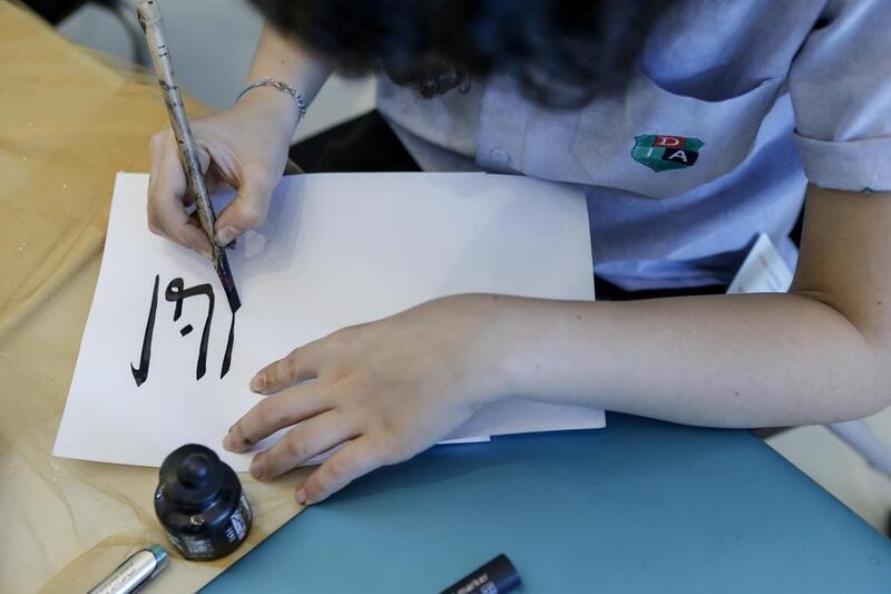 A student in Dubai practices Arabic Calligraphy (Photo: Antonie Robertson)