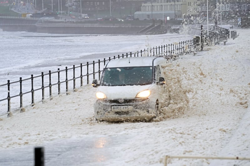 A van drives through sea foam in Seaburn, Sunderland, north-east England. PA
