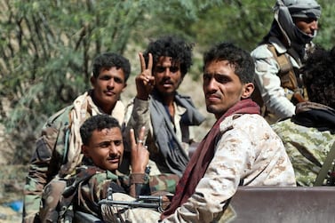 Forces loyal to Yemen's Saudi-backed government flash the victory sign as they deploy west of the country's third-city of Taez, on March 16, 2021. AFP