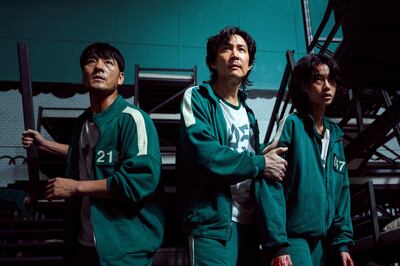 South Korean cast members, Park Hae-soo, Lee Jung-jae and Jung Ho-yeon in a scene from 'Squid Game.' Photo: Netflix 