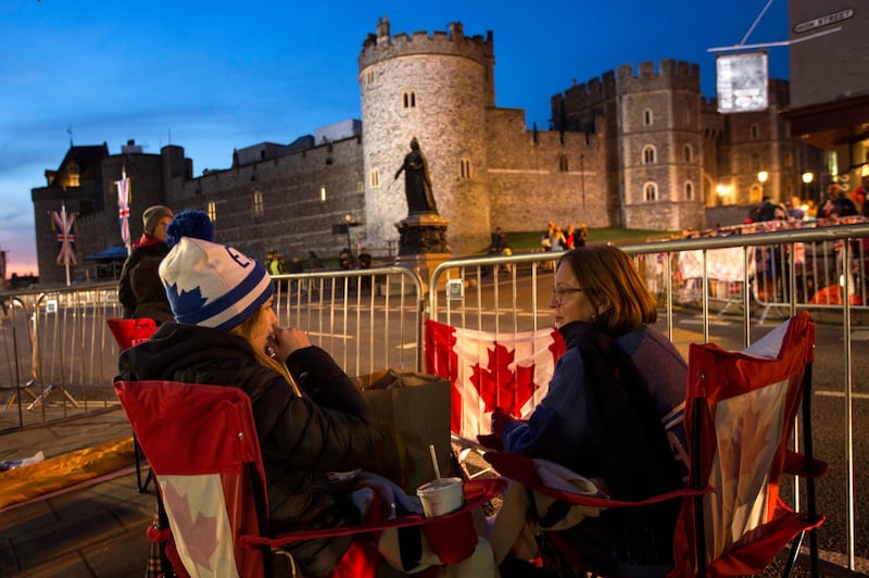 A group of woman from Canada sit outside Windsor Castle. Emilio Morenatti / AP Photo