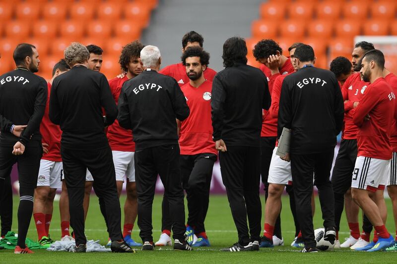 Egypt's forward Mohamed Salah, centre, listens to coach Hector Cuper, front, third left, as he gives instructions during a training session at Ekaterinburg Stadium in Ekaterinburg. Jorge Guerrero / AFP
