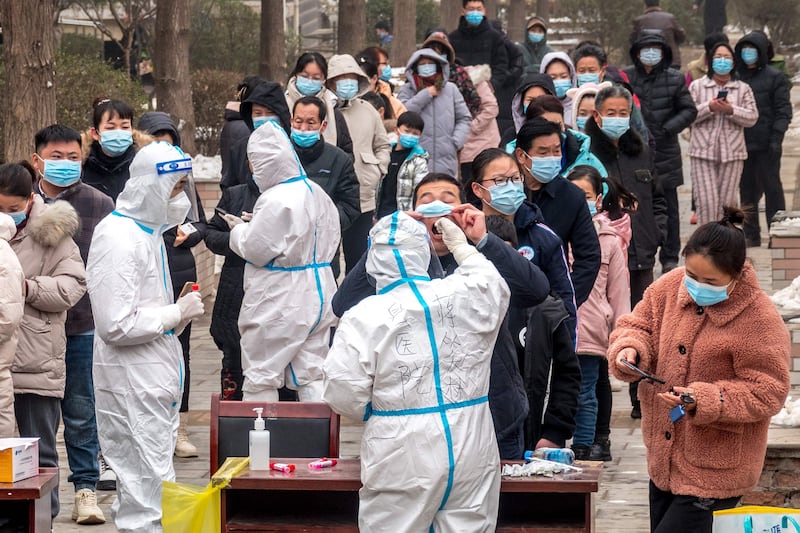 Residents undergo nucleic acid tests at a Covid-19 test centre in Anyang, China. AFP
