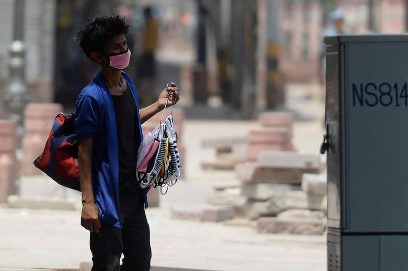 A mask seller in New Delhi looks for business during a lockdown as coronavirus case numbers rise. AFP