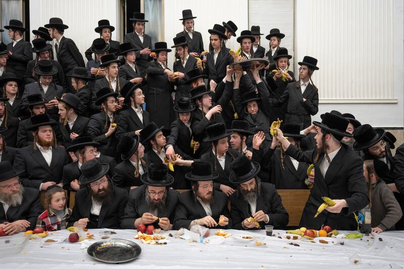 Ultra-Orthodox Jews of the Zweil Hasidim distribute fruit at the feast of Tu Bishvat in Jerusalem. AP

