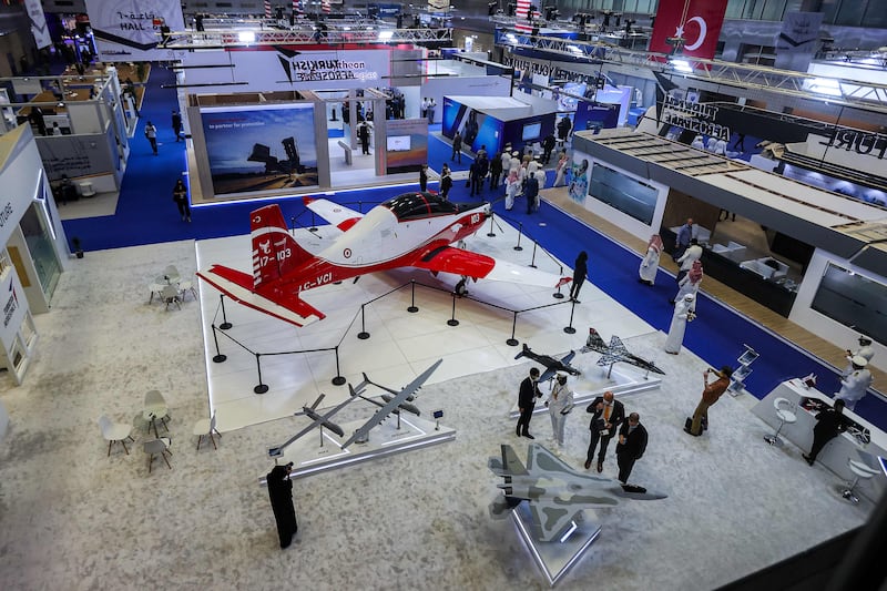 A Turkish Aerospace Industries' propeller-driven Hürkus (Free Bird) trainer and ground attack aircraft on display with scale models of other planes at the Doha International Maritime Defence Exhibition in the Qatari capital.