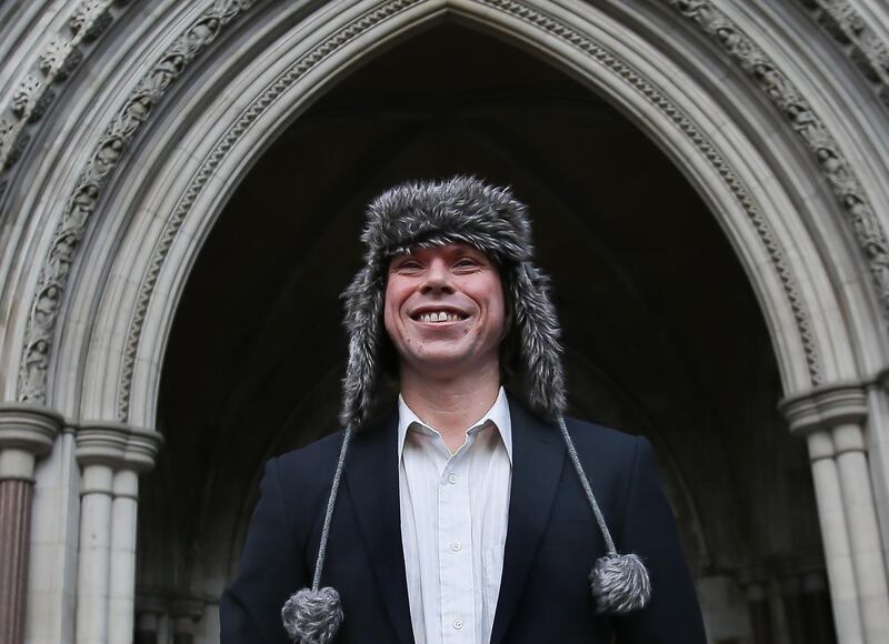TOPSHOT - British student Lauri Love, (L), who is accused of hacking into US government websites, poses outside the Royal Courts of Justice in central London on February 5, 2018.
The ruling in Lauri Love's appeal against extradition to the United States will be handed down at the Royal Courts of Justice on February 5. / AFP PHOTO / Daniel LEAL-OLIVAS