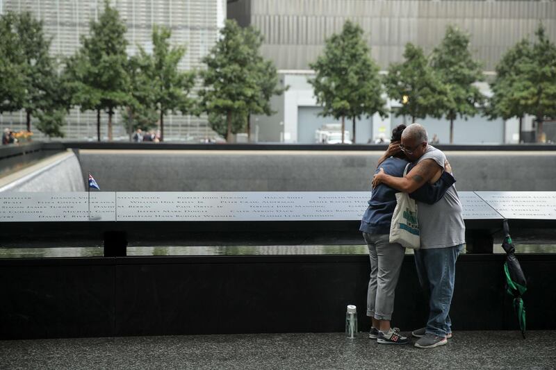 Mourners embrace during a commemoration ceremony for the victims of the September 11 terrorist attacks at the National September 11 Memorial. AFP