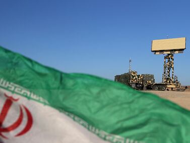 A handout photo made available by the Iranian Army office on October 21, 2020, shows a national flag in front of an Iranian radar system system during the first day of the air defense exercise of 'Aseman Velayat 99', in an unidentified location in Iran. The Iranian armed forces today launched military air defense exercises to test "local" systems, state media reported, three days after the expiration, according to Tehran, of a UN embargo on the sale of weapons to Iran. (Photo by Iranian Army office / AFP) / XGTY / === RESTRICTED TO EDITORIAL USE - MANDATORY CREDIT "AFP PHOTO / HO / IRANIAN ARMY OFFICE" - NO MARKETING NO ADVERTISING CAMPAIGNS - DISTRIBUTED AS A SERVICE TO CLIENTS === - XGTY / === RESTRICTED TO EDITORIAL USE - MANDATORY CREDIT "AFP PHOTO / HO / Iranian Army office" - NO MARKETING NO ADVERTISING CAMPAIGNS - DISTRIBUTED AS A SERVICE TO CLIENTS === / 