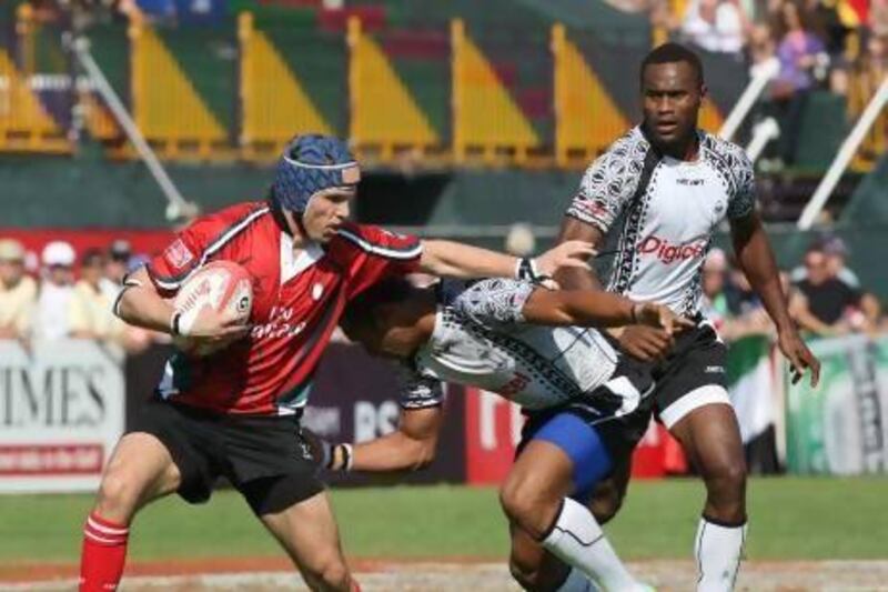 UAE's Tim Fletcher battles for yardage as Fiji defenders take him down near the try line during action back in 2011 at the Emirates Airlines Dubai Rugby Sevens.