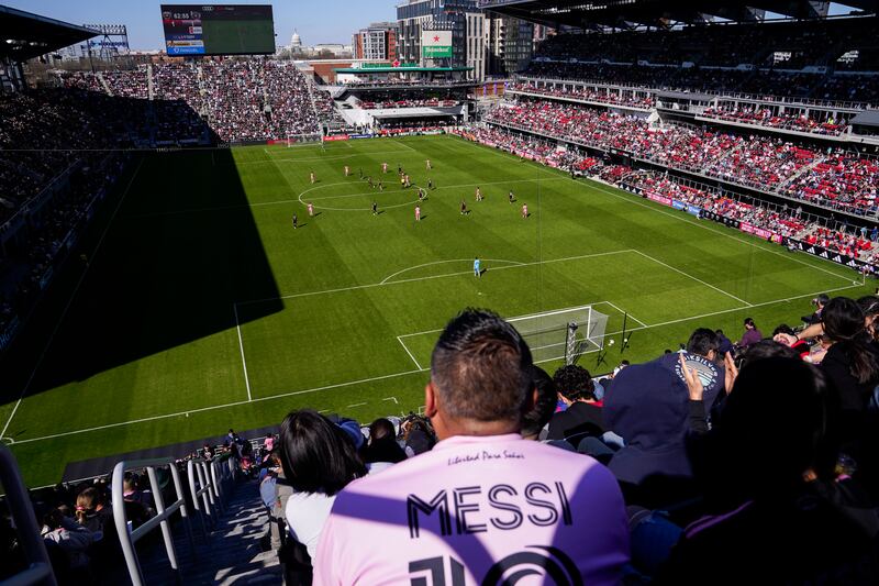 A fan wearing a Lionel Messi jersey watches the match at Audi Field. AP