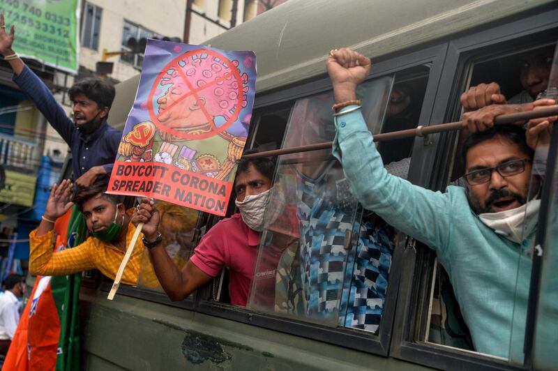 Activists belonging to the Bharatiya Janata Party shout slogans while holding posters as they sit in a police van during an anti-China protest in the eastern Indian city of Siliguri. AFP