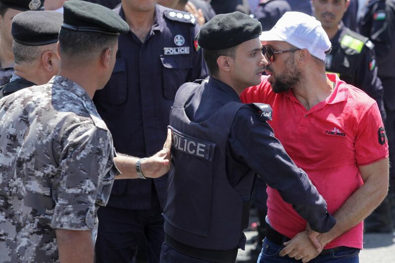 A Jordanian teacher confronts security forces during a protest in the capital Amman.  AFP