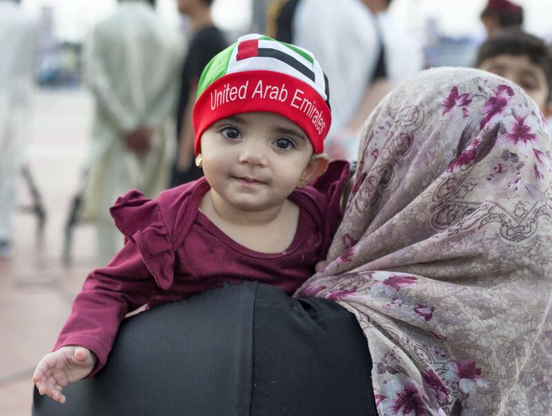Abu Dhabi, United Arab Emirates - A baby with UAE cap on to celebrate the UAE National Day at Abu Dhabi Corniche, Breakwater.  Leslie Pableo for The National