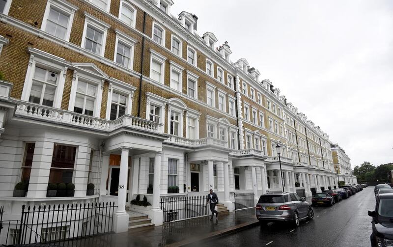 A man walks along an upscale residential street in London. Hannah McKay / Reuters