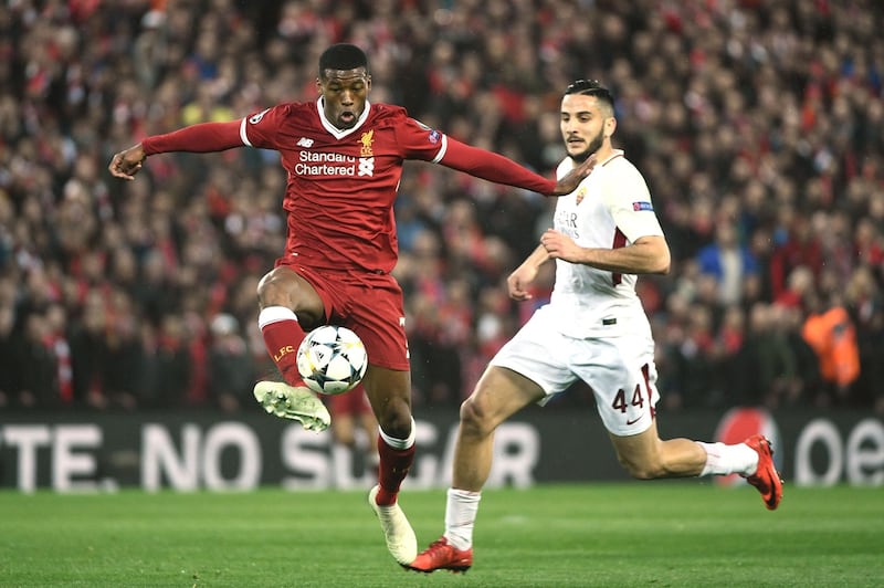 Liverpool's Dutch midfielder Georginio Wijnaldum (C) controls the ball during the UEFA Champions League first leg semi-final football match between Liverpool and Roma at Anfield stadium in Liverpool, north west England on April 24, 2018. / AFP PHOTO / Filippo MONTEFORTE